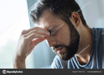 depositphotos_166641370-stock-photo-moody-young-man-holding-a.jpg